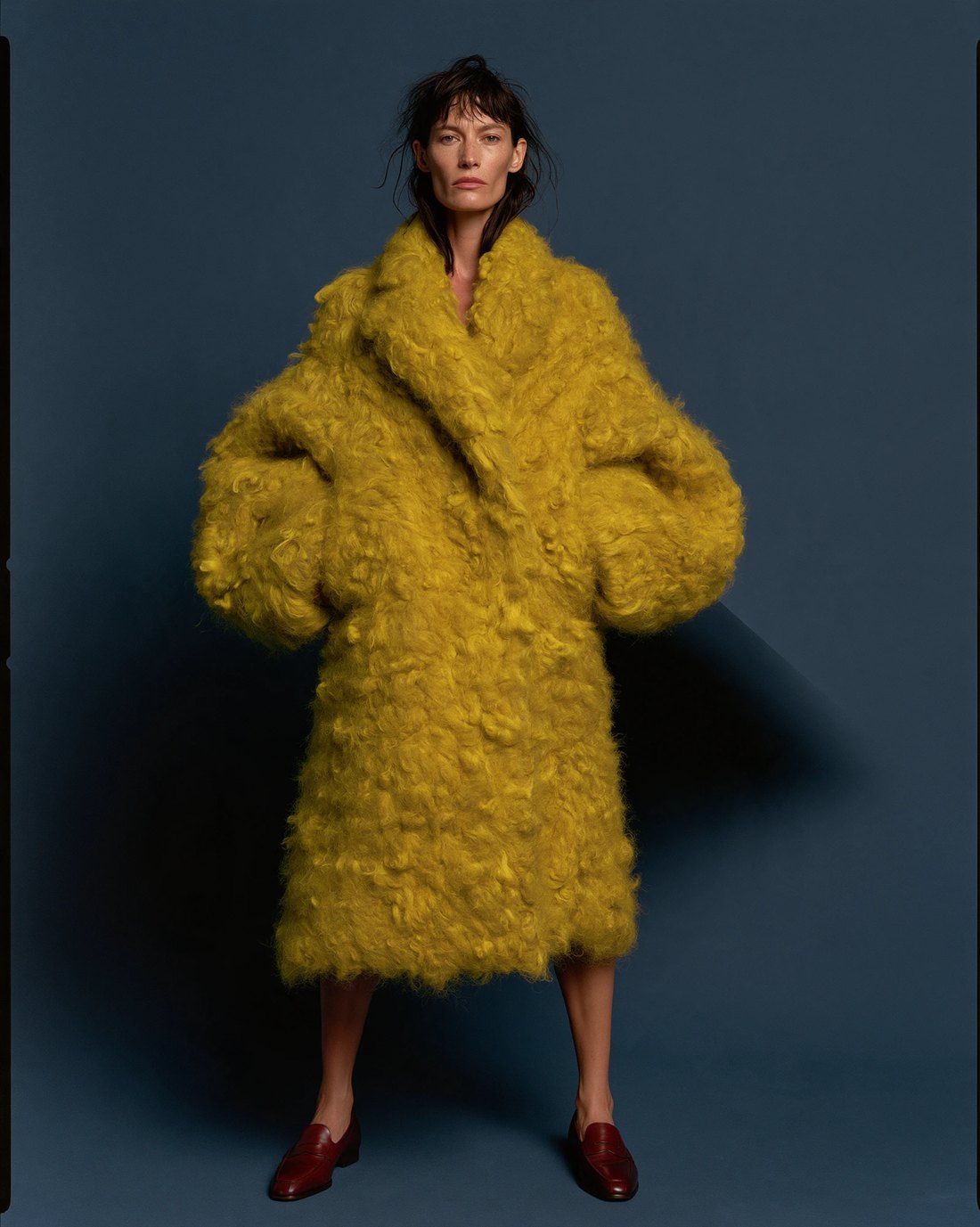 Yellow mohair coat against a deep blue ground